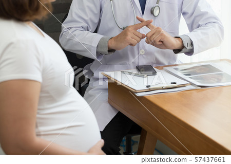 Doctor showing warning with hand sign and talking 57437661