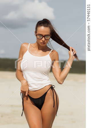 Pretty female in beachwear on nature background Pretty female in beachwear on nature background 57440131