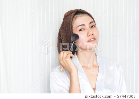 Beautiful asian woman holding make-up brush. Beauty and Healthy concept Beautiful asian woman holding make-up brush. Beauty and Healthy concept 57447305