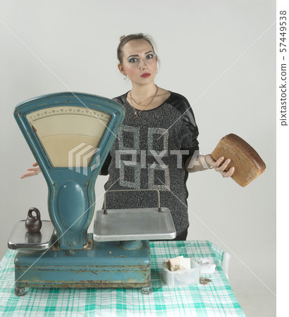 saleswoman at the grocery store. behind the saleswoman at the grocery store. behind the 57449538