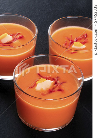 Salmorejo, Spanish cold tomato soup, in glasses, close-up shot on a black background Salmorejo, Spanish cold tomato soup, in glasses, close-up shot on a black background 57452338