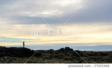 Man sihouette on Icealnd rock formatoin beautiful 57455468