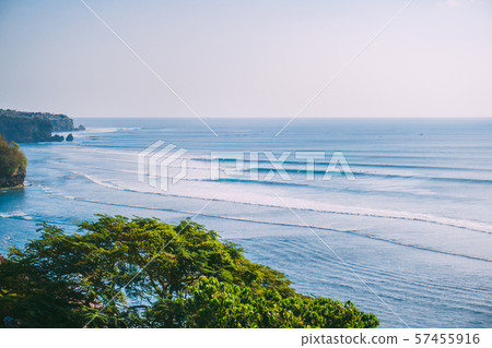 Blue big waves for surfing in Bali, Tropical tree and ocean waves in Indonesia Blue big waves for surfing in Bali, Tropical tree and ocean waves in Indonesia 57455916