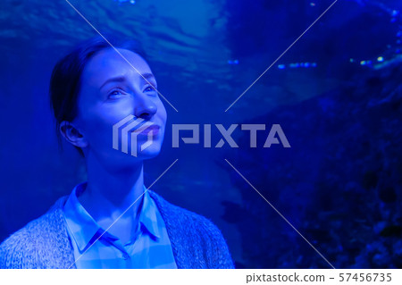 Woman looking at fish in large public aquarium tank at Oceanarium Woman looking at fish in large public aquarium tank at Oceanarium 57456735