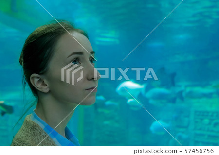 Woman looking at fish vortex in large public aquarium tank at Oceanarium Woman looking at fish vortex in large public aquarium tank at Oceanarium 57456756
