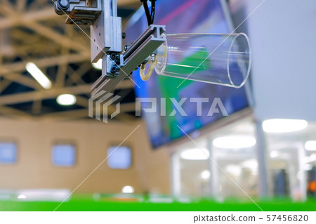 Automatic robotic arm manipulator with suction cups moves plastic clear cup Automatic robotic arm manipulator with suction cups moves plastic clear cup 57456820