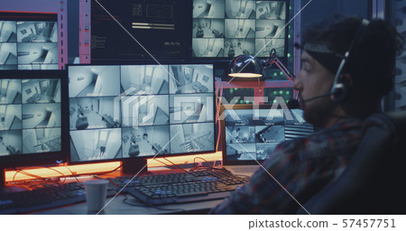 Hacker watching security camera footage 57457751