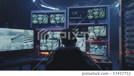 Hacker watching security camera footage 57457752