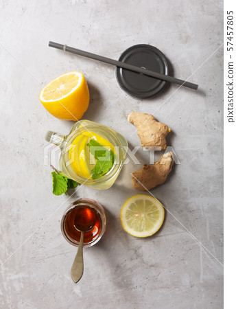 Ginger Water in Glass jar With Lemon and Honey on a Gray Concrete Background 57457805