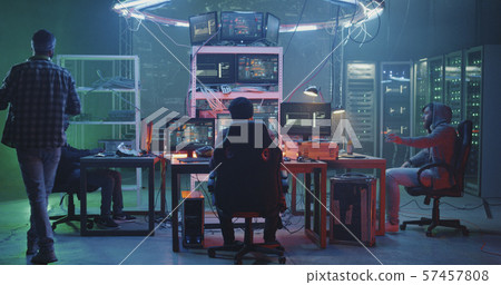 Young hackers talking in basement 57457808