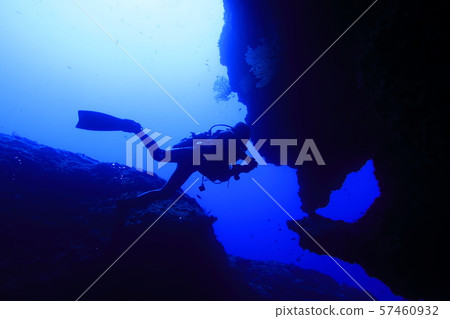 Diver swimming in the Queen's room in a submarine cave at a diving spot in Shimojijima, Miyakojima City 57460932