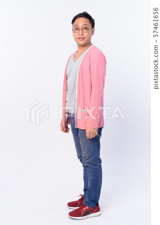 Full body shot profile view of Japanese man looking at camera Full body shot profile view of Japanese man looking at camera 57461656