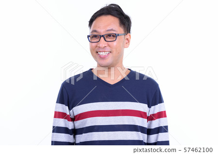 Happy Japanese hipster man with eyeglasses thinking and looking away 57462100