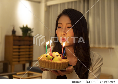 Young woman with a candle on a candle in the room Young woman with a candle on a candle in the room 57462266