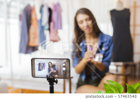 Closeup smart mobile phone taking Live Beautiful young woman Sell online. Vlog concept. 57463548