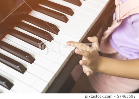 Close up children hand practice playing the piano. 57463592