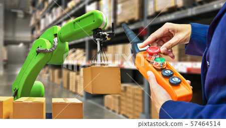 Industrial robot holding a box and worker operating a robot machine on stock shelves background 57464514