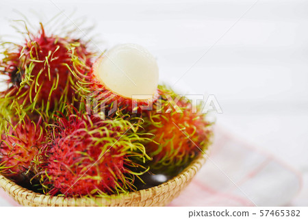 Rambutan peeled in a basket on table background / 57465382