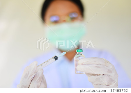 Syringe medication injection and needle in hand Syringe medication injection and needle in hand 57465762