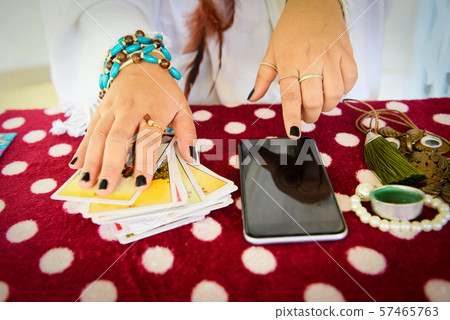 Fortune teller reading fortune lines on screen 57465763