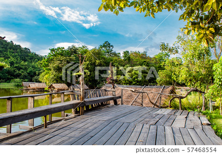 The wooden terrace and chairs on the reservoir. The wooden terrace and chairs on the reservoir. 57468554