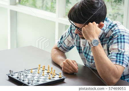 Casual businessman playing chess game with retro Casual businessman playing chess game with retro 57469051