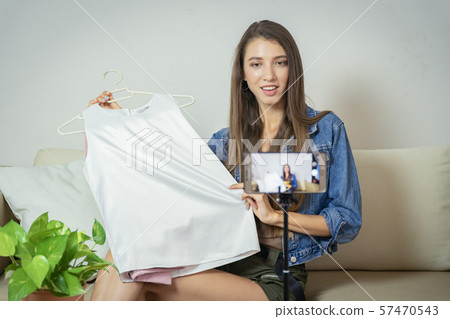 Young girl selling clothes online by live Young girl selling clothes online by live 57470543