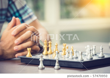 Casual businessman playing chess game with retro 57470950