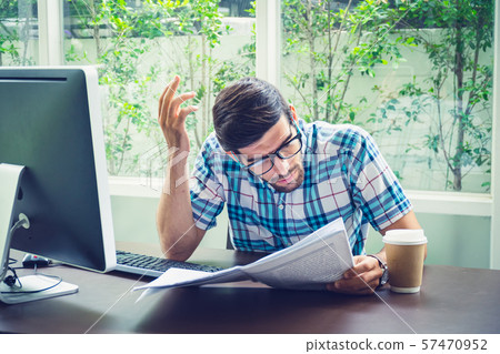 Young casual businessman reading business news in Young casual businessman reading business news in 57470952