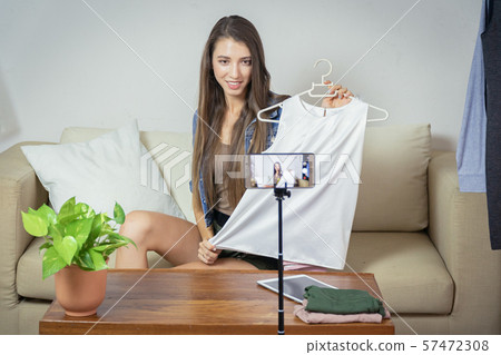 Young girl selling clothes online by live Young girl selling clothes online by live 57472308