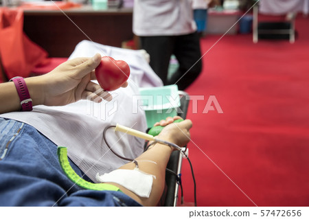 Blood donor at donation with a bouncy ball holding in hand. 57472656