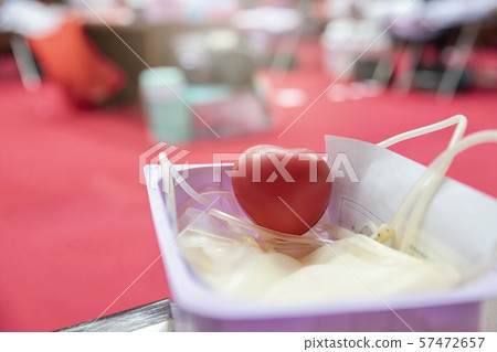 A red heart bouncy ball with blood bag in basket. 57472657