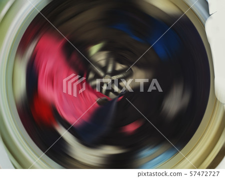Top view of a washing machine drum during spinning clothes. Top view of a washing machine drum during spinning clothes. 57472727