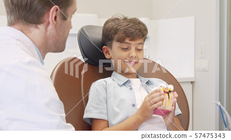 Lovely little boy visiting dentist for teeth examination 57475343