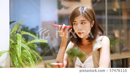 Young woman listen to voicemail Young woman listen to voicemail 57476110