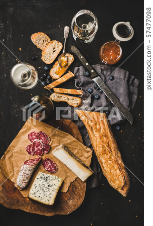 White wine and different snacks over black White wine and different snacks over black 57477098