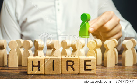 Wooden blocks with the word Hire. 57477577