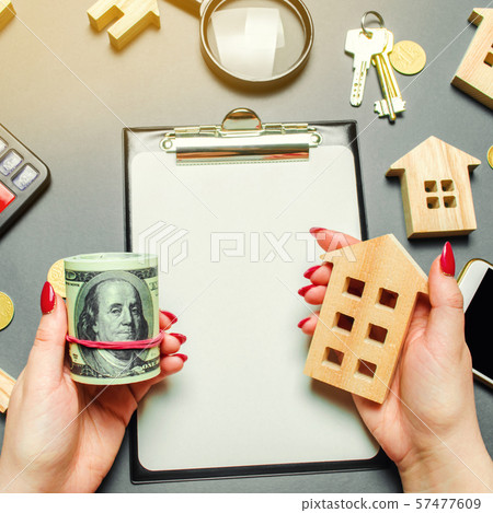 A girl holds in his hands a dollars A girl holds in his hands a dollars 57477609