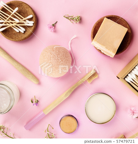 Plastic-free, zero waste cosmetics, flat lay on a pink background. Bamboo toothbrushes and cotton 57479721