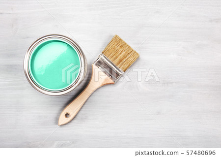 Paint brush on the can with green paint. Top view. 57480696