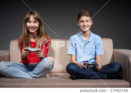 Computer game competition. Gaming concept. Excited girl playing video game with joystick Computer game competition. Gaming concept. Excited girl playing video game with joystick 57482149