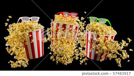 Set of bucket with popcorn and 3D glasses isolated on black background 57483917