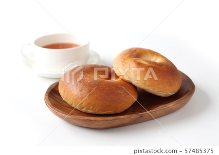 Bagel plain bread on a plate white background Bagel plain bread on a plate white background 57485375