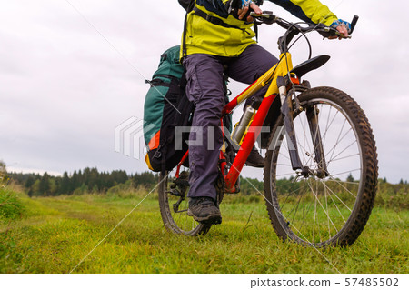 tourist bike riding through the field, closeup tourist bike riding through the field, closeup 57485502