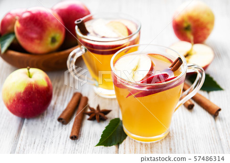 Apple cider  with cinnamon sticks 57486314
