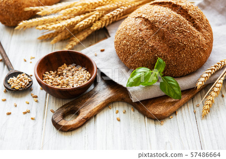 Bread on a old white wooden table 57486664