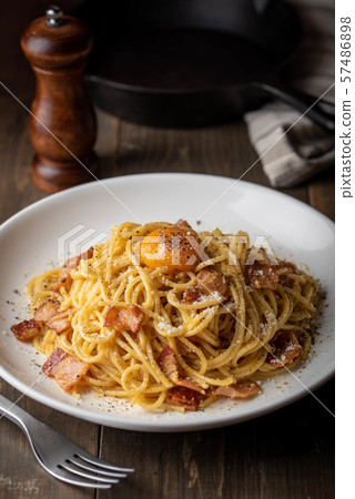 carbonara spaghetti with raw egg yolk on top 57486898