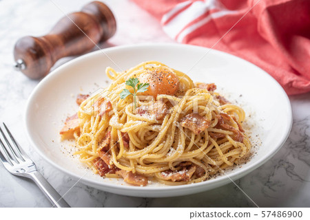 carbonara spaghetti with raw egg yolk on top 57486900