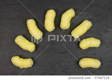 Salted corn puff on grey stone Salted corn puff on grey stone 57487129