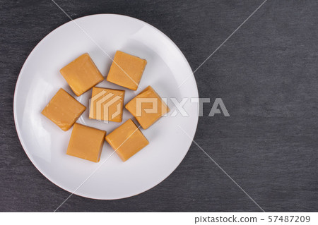 Sweet caramel candy on grey stone Sweet caramel candy on grey stone 57487209